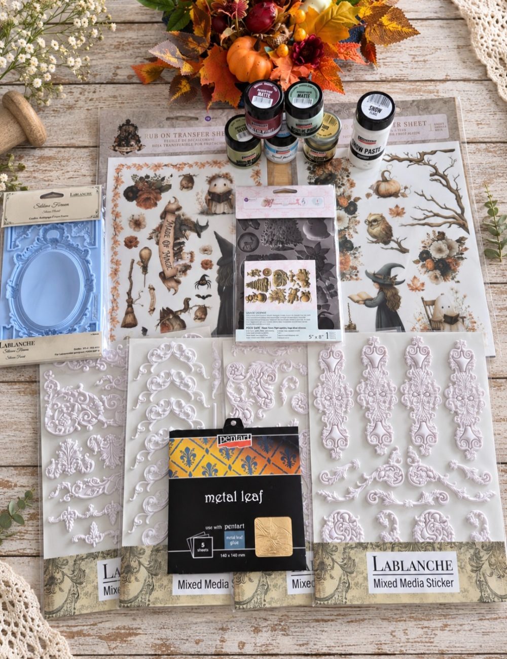 Chalk paints, transfers and craft materials on the workbench